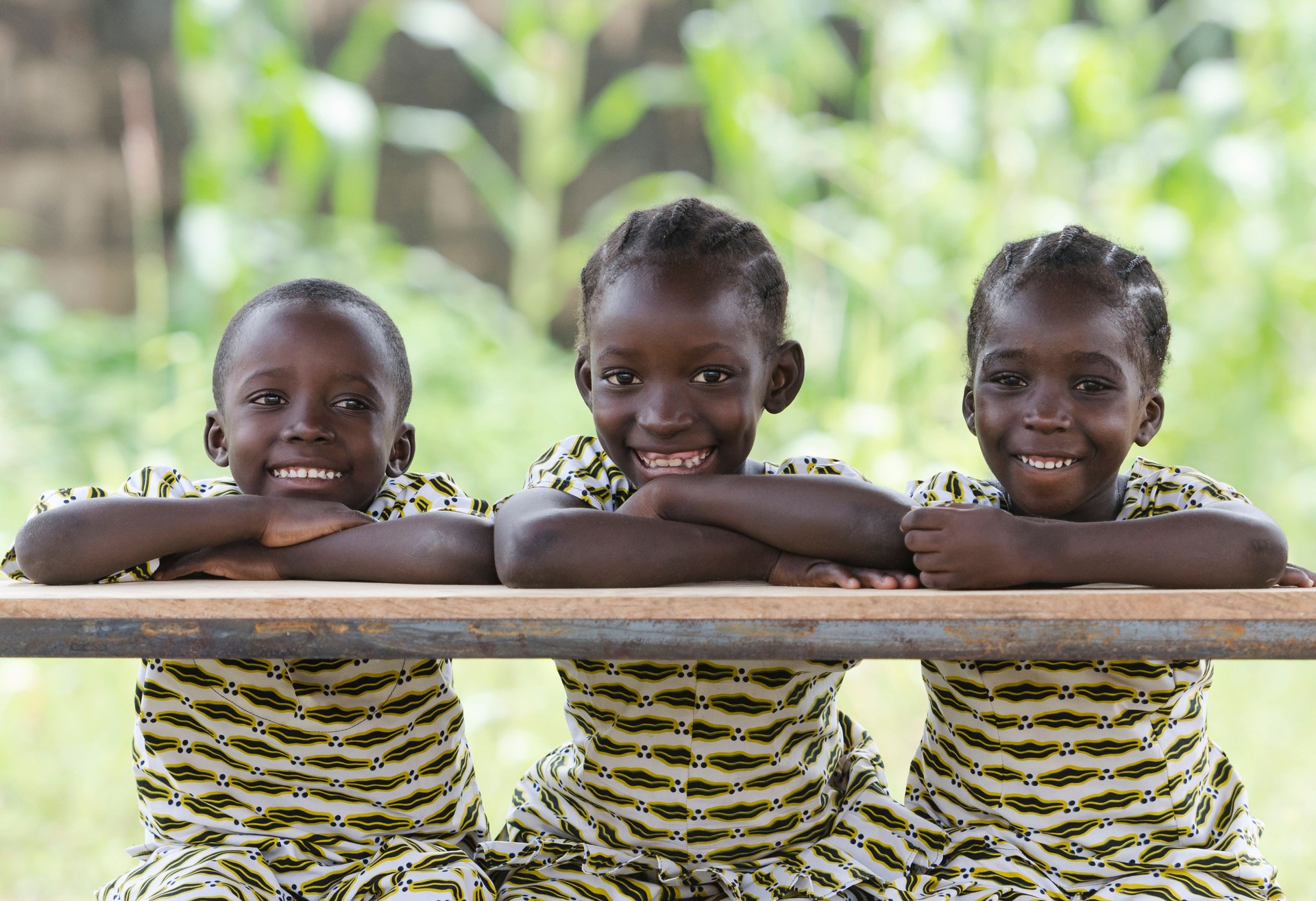 Three African Children at School Education Symbol Schoolgirl Schoolboy Sitting