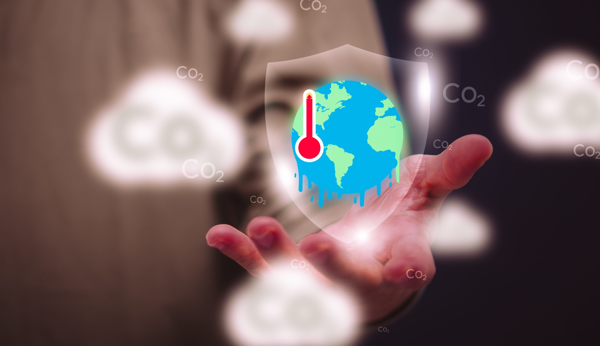 environmental conservation concept A conservationist is showing realistic images of a world with rising temperatures and melting earth on his hands. To be aware of global temperature changes
