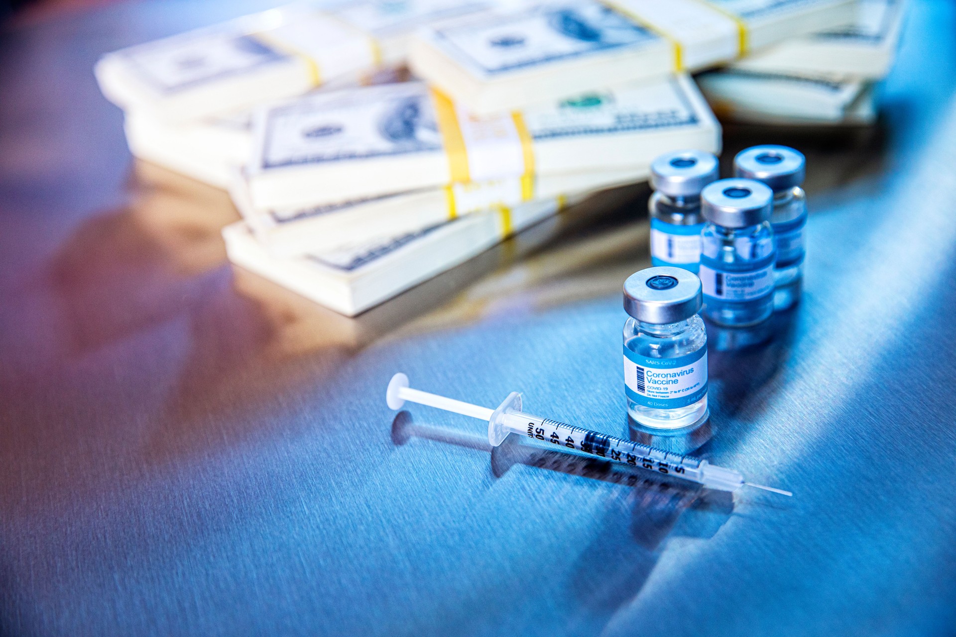 Coronavirus vaccine vials in hospital with money