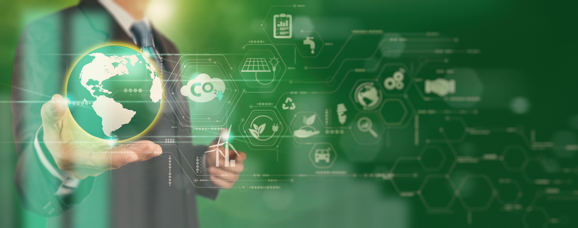 Businessman working virtual globe modern computer to reduce CO2 emissions carbon footprint climate change to limit global warming.Sustainable development and innovation green business concept.